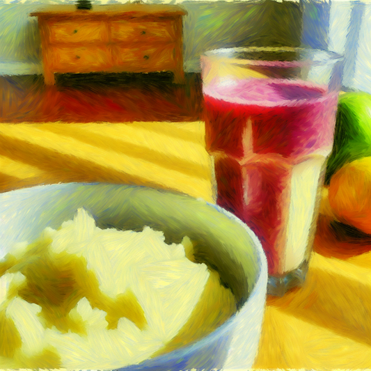  A soft bowl of mashed potatoes and a colorful smoothie on a table, evoking a...